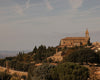 Panoramic view of Tuscan hilltop town with greenery and blue skies