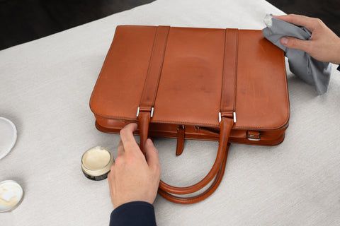 Waterproofing a brown leather briefcase with wax