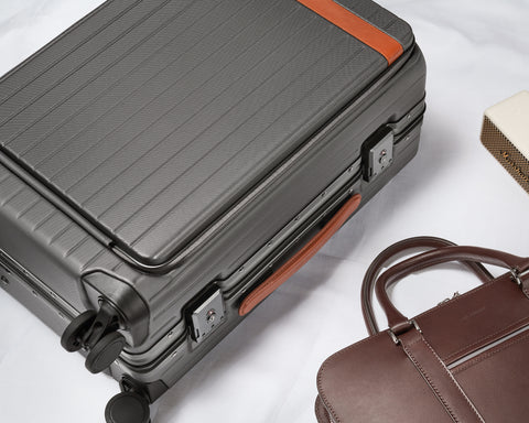 Carry-on suitcase and brown leather briefcase