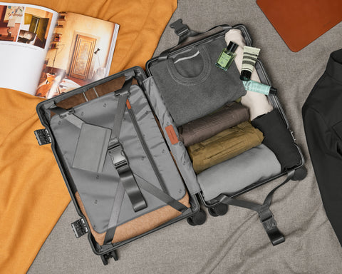 Neatly folded travel accessories inside carry-on suitcase