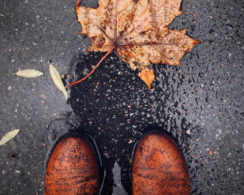 Brown leather boots in the rain