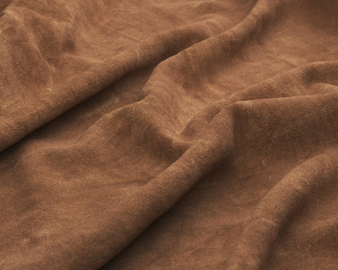 Creased sheet of brown suede leather