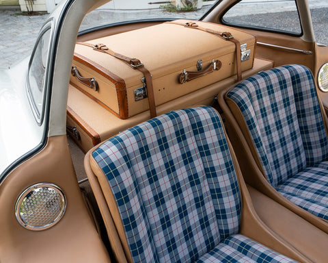 Vintage suitcase inside of a vintage car