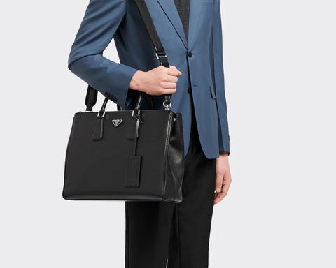 Stylish model wearing men's Saffiano leather Prada bag