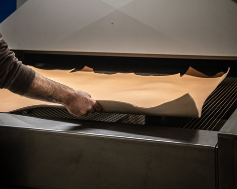 Brown leather being treated in a tannery