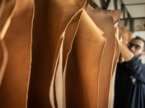 Leather sheets being hung to dry by a leather worker