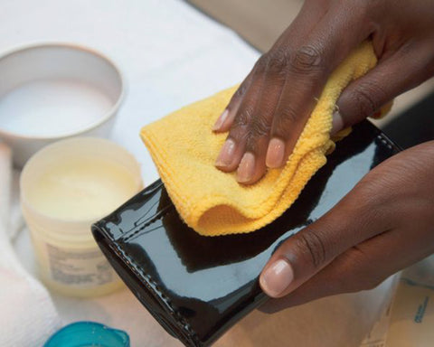 Cleaning black patent leather with yellow microfibre cloth