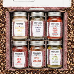 6 bottles of different Burlap and Barrell spices shown in a gift box 