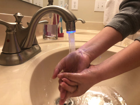 SinkBlink20 on running faucet with hands being washed under running water