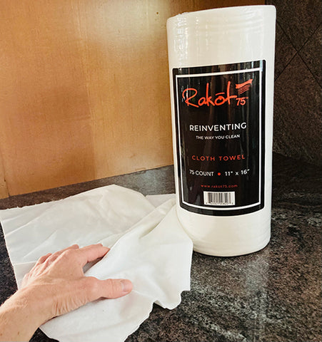 Rakot75 Cloth Towels with hand wiping a black countertop