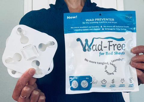 Wad-Free for Bed Sheets package and two white products held by a woman in blue shirt