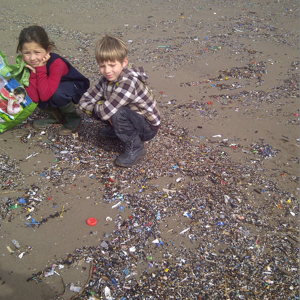 Children amongst the microplastics on Tregantle Beach, SE Cornwall, UK