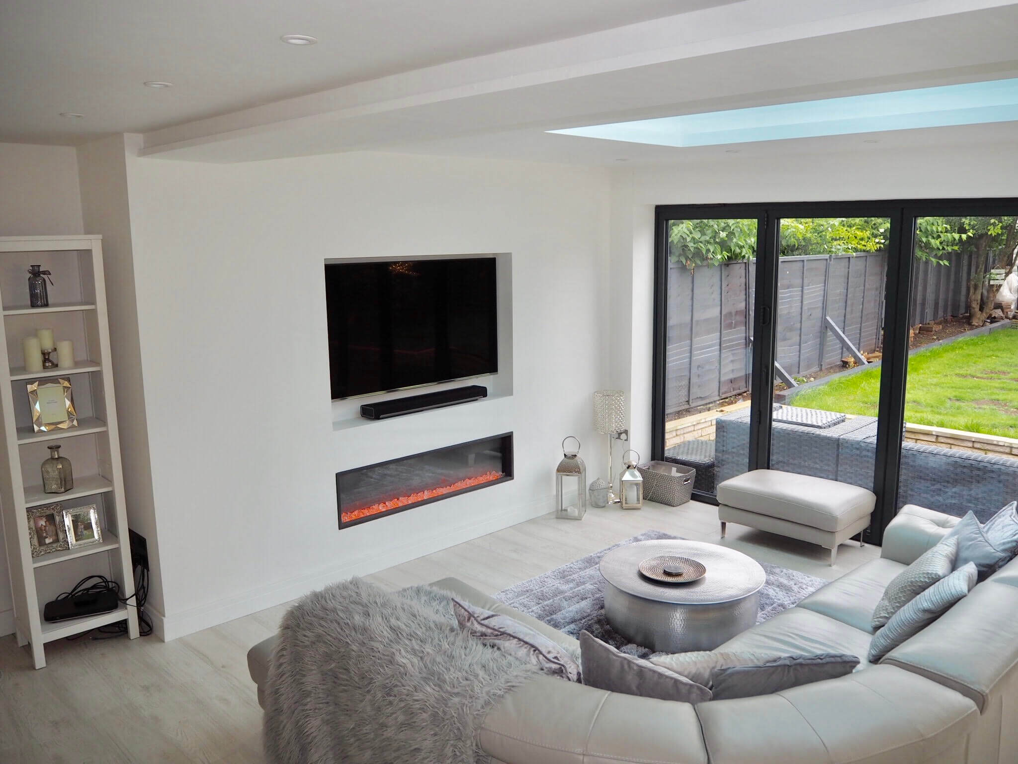 Check out this Scandinavian inspired white modern contemporary open plan kitchen living room with bi folding doors.