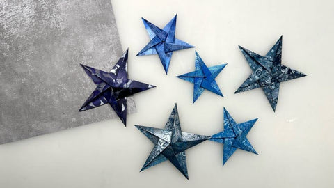 6 origami stars folded out of blue gel printed washi paper