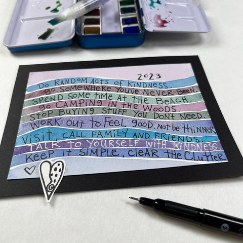 picture of watercolor lines with new year's resolutions hand lettered on the lines