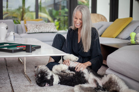 April Grant in niLuu lounging with dog