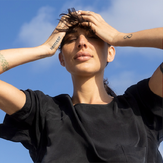 A person with her hair in the air