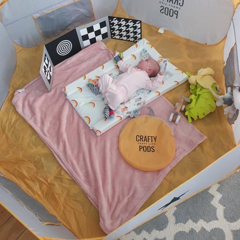 Baby on baby mat in a Crafty Pod