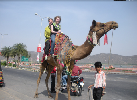Mary Liz and Keara traveling in India on a camel.