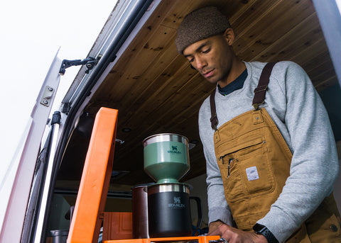 Elijah making pour over coffee in his Dodge RAM ProMaster 2500