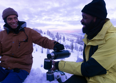 Elijah pours Kenny a Hot Toddy from his Stanley vacuum bottle after a long day of snowboarding at Timberline Resort.