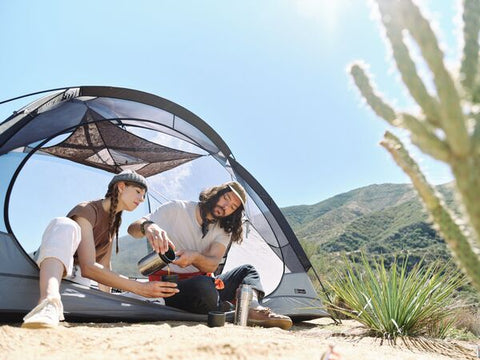 Couple camping in the desert using Stanley's Bowl+Spork Compact Cook Set.