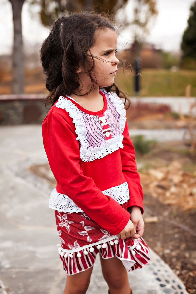 white dress with colorful pom poms