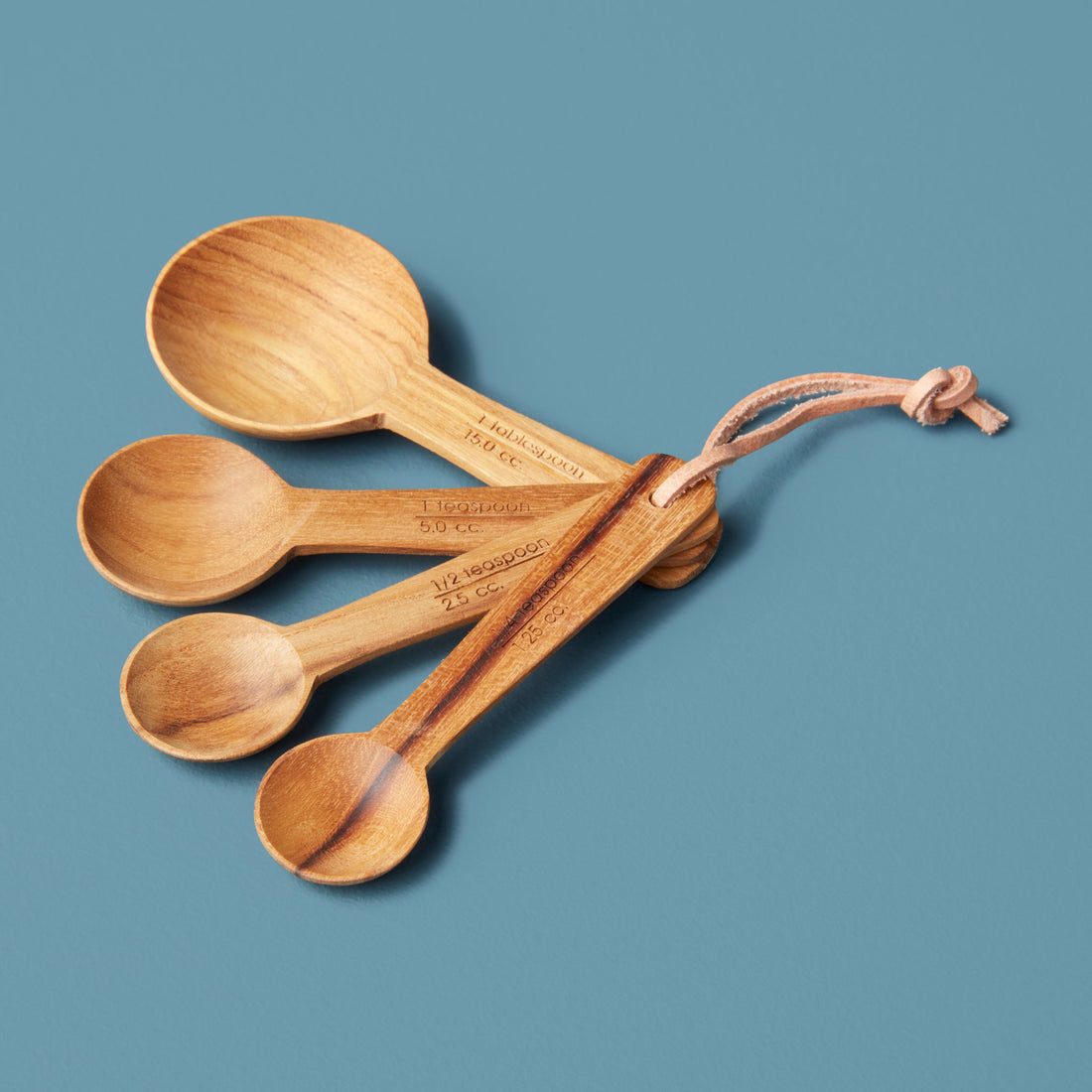 https://cdn.shopify.com/s/files/1/0376/0920/9900/products/Be-Home_Teak-Round-Measuring-Spoons-Set-of-4_39-66.jpg?v=1605656876&width=1100