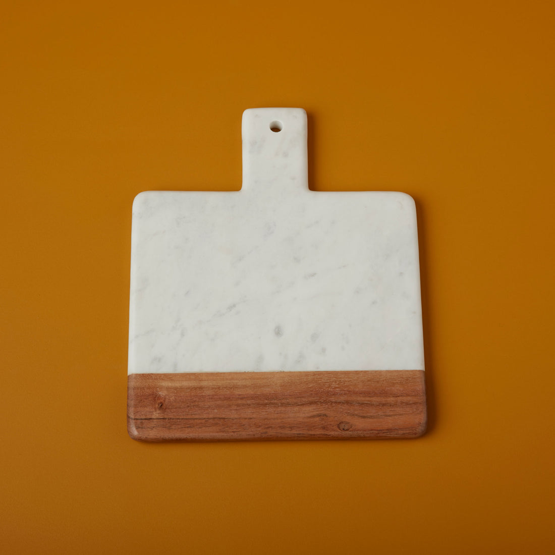 https://cdn.shopify.com/s/files/1/0376/0920/9900/products/Be-Home_White-Marble-and-Acacia-Wood-Square-Handled-Board_58-65.jpg?v=1612978274&width=1100