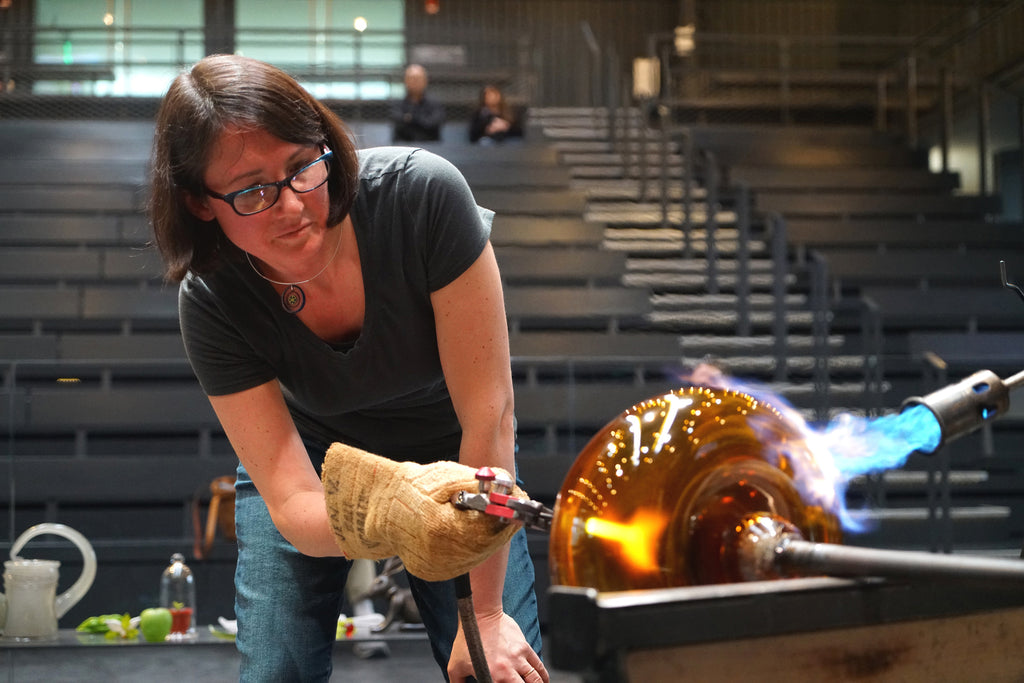 Jen Violette blowing glass sculpture, a Large Hilltop piece for the Rural Landscape Series, at the Corning Museum of Glass; the finished piece had two bronze barns and was sold at Ellenbogen Gallery in Manchester, VT.