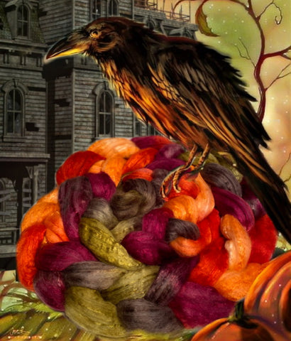 A crow sitting on top of a handdyed fibre in autumnal colours resembling a pumpkin