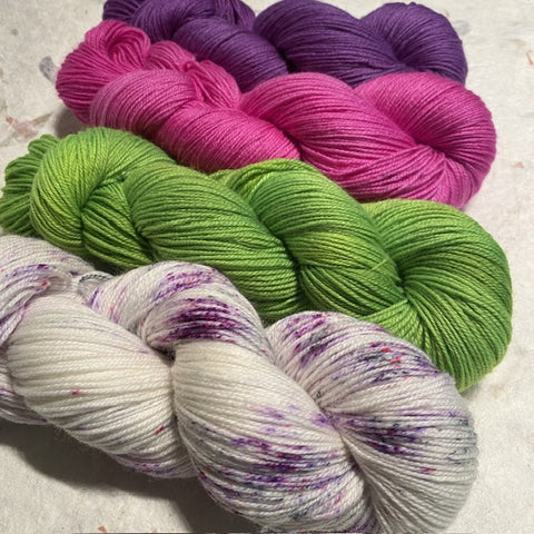 Geogradient yarn set from light speckled purples to absinthe lime greens to raspberry pink to witchy bright purples