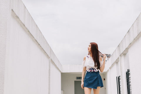 Alicia Tan in the Drascia Organza Cold Shoulder Top with Graphic Prints in Light Pink & Fleur Wrap Front Skort in Light Denim