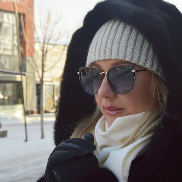Woman wearing sunglasses in snow