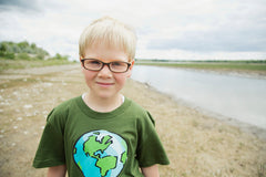 Boy wearing glasses and earth friendly t-shirt