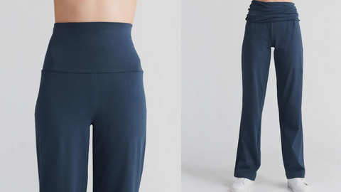 Model wearing Organic Cotton Navy Yoga Pants 1st image shows close up of extendable waistband, 2nd image full length loose fit Yoga pants