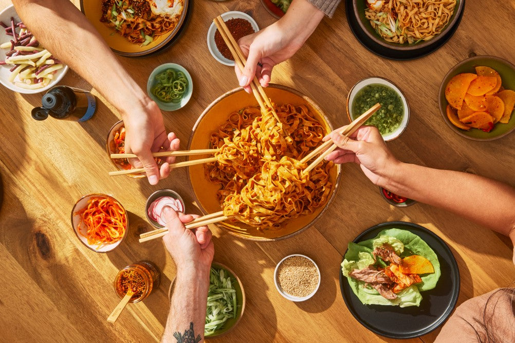 bowl of noodles shared between friends