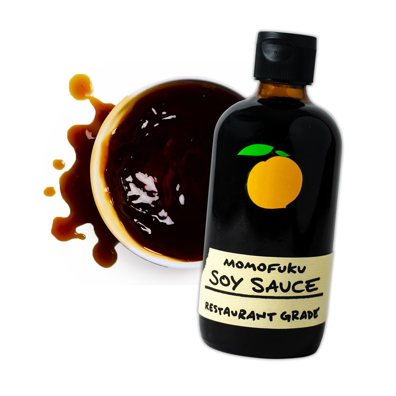 A bottle of Momofuku soy sauce next to a spilled bowl of soy sauce.