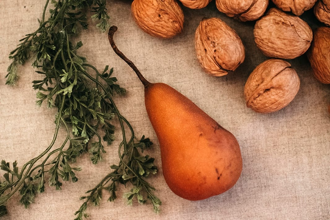 Pear decor on Thanksgiving table with walnuts