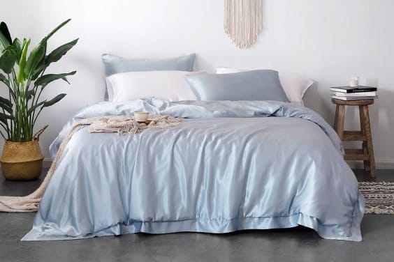 sky blue silk bedding on a bed