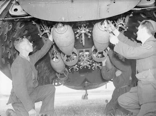 Armourers secure 250-lb GP bombs in the bomb-bay of a Lockheed Hudson of No. 224 Squadron RAF at RAF Leuchars