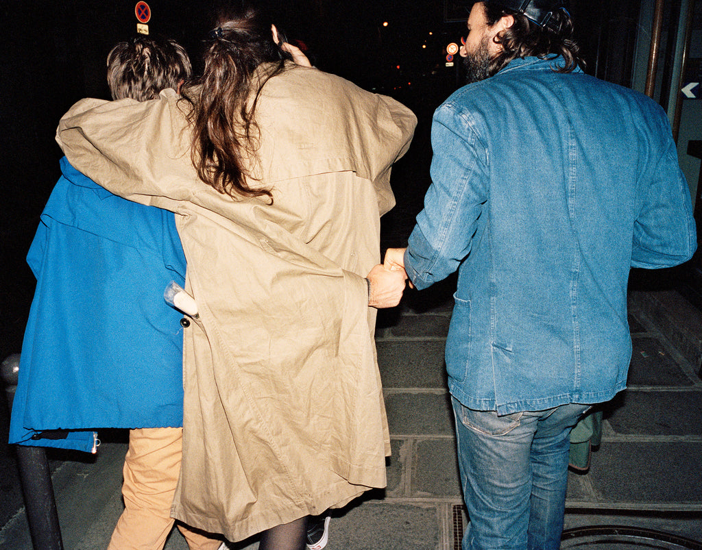 Friends walking together at night in Paris