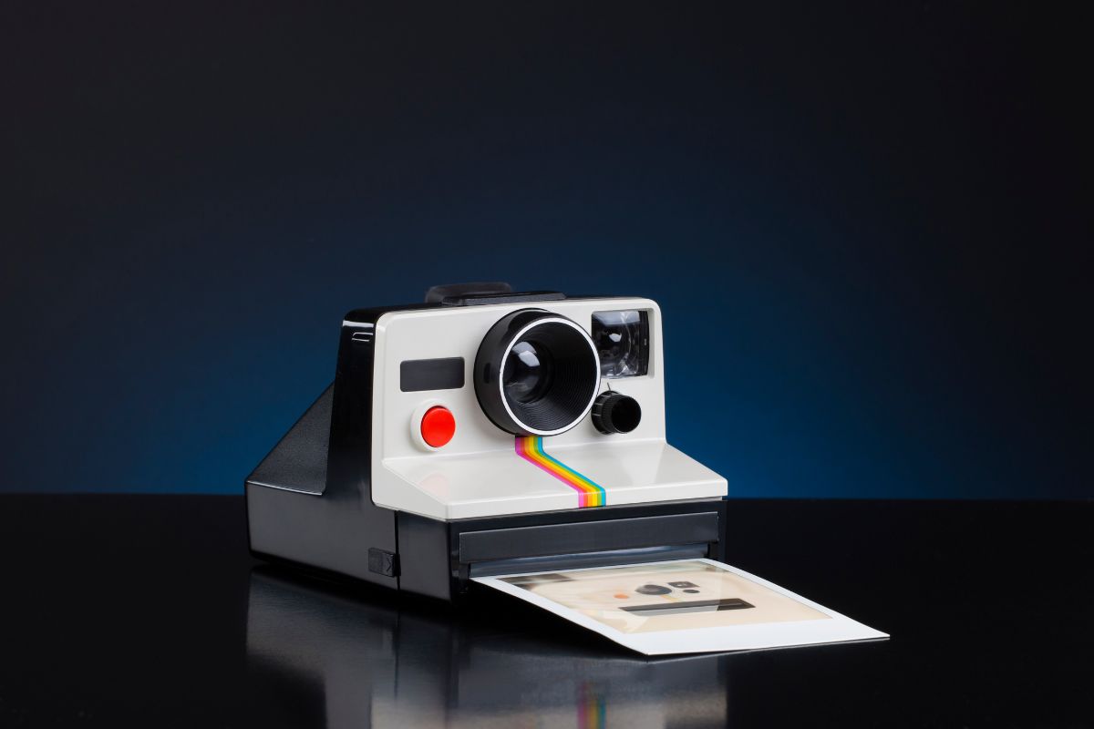 A Polaroid Now camera printing a photo