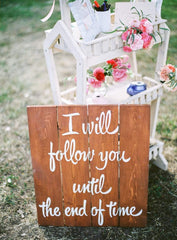 A board at a wedding that was photographed by a film camera, it reads I will follow you until the end of time.