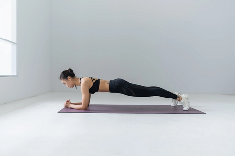 a women holding the plank pose