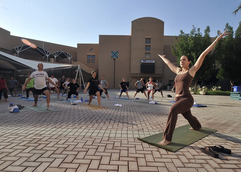 a yoga instructor conducting a class outdoors