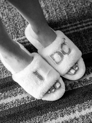 Bride wears fuzzy slippers that say "I Do" while getting ready for her wedding.