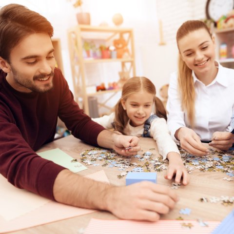 children put puzzles together with adults