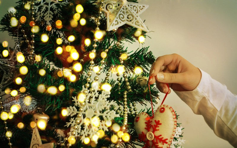 decorating christmas tree on bright background