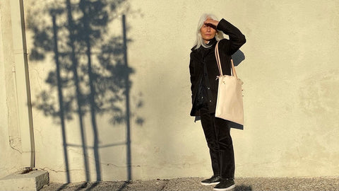 Edie Kahula Pereira modeling Edie Kahula Pereira Goods (aka Specialty Dry Goods) Raffia bag in veg tan leather self shooting  IRL in her Santa Monica neighborhood.